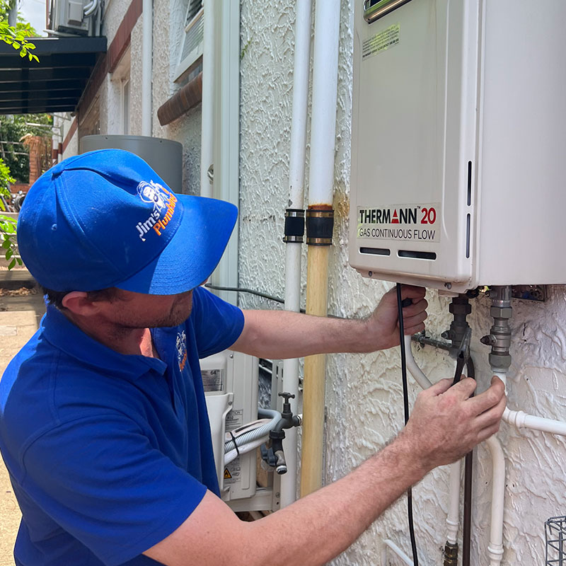 Plumber installing Thermann tankless hot water heater